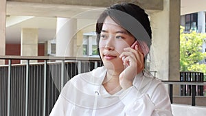 Portrait of thai adult student university beautiful girl calling smart phone