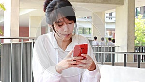 Portrait of thai adult student university beautiful girl calling smart phone