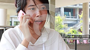 Portrait of thai adult student university beautiful girl calling smart phone