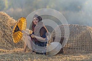 Portrait Thai beautiful woman farmer holding umbrella outdoor,countryside Thailand.