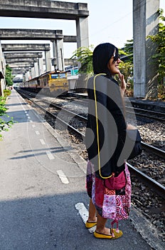 Portrait Thai woman with Train on Railway at Thail