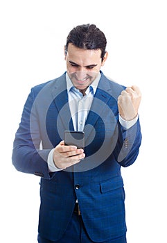 Portrait of thankful and pleased businessman keeps fist raised up, looking contented upwards isolated on white background.
