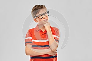 Portrait of thinking boy in eyeglasses
