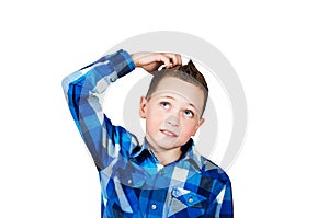 Portrait of thinking boy with hand at face, looking up. Isolated on white background