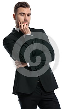Portrait of thoughtful businessman in black tuxedo thinking