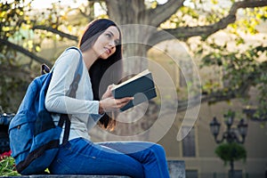 Portrait of a thoughtful female sutdent holding book