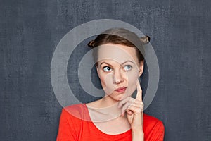 Portrait of thoughtful focused girl imagining something in mind