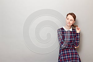 Portrait of thoughtful girl being deep in thoughts or being bored