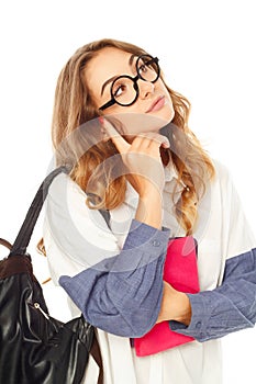 Portrait of a thoughtful girl wearing glasses looking up over white background