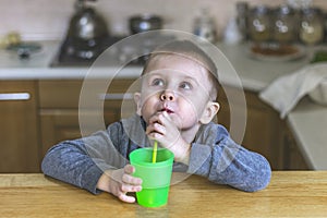 Portrait of thoughtful little boy in the kitchen at home.