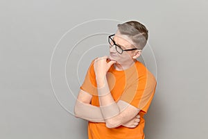 Portrait of thoughtful man touching chin with hand and smiling