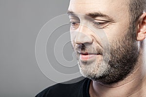 Portrait of thoughtful mature caucasian man isolated on gray