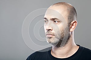 Portrait of thoughtful mature caucasian man isolated on gray