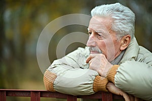 Portrait of thoughtful senior man in park