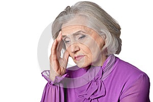 Portrait of thoughtful senior woman with headache