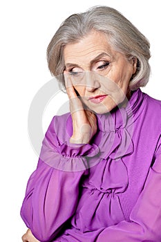 Portrait of thoughtful senior woman with headache on white background