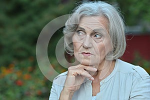 Portrait of thoughtful senior woman in park