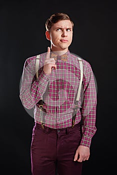 Portrait of thoughtful serious clever scientific man in vintage shirt bow tie with hairstyle keeping finger raised while standing