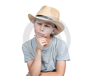 Portrait of a thoughtful teenager in a man\'s straw hat, isolated on a white background.