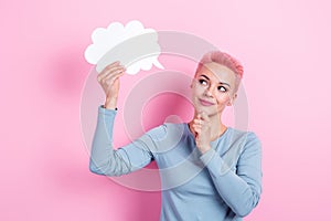 Portrait of thoughtful woman with dyed hairdo wear stylish clothes look at dialog cloud hand on chin isolated on pink