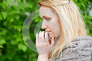 Portrait of thoughtful woman in hand-knitted jacket