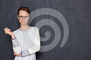 Portrait of thoughtful young woman with glasses, waiting the results