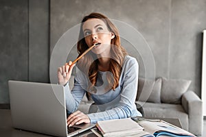 Portrait of a thoughtful young woman studying