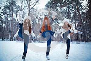 Portrait of three beautiful girls in winter park