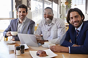 Portrait Of Three Businessmen Having Meeting In Coffee Shop