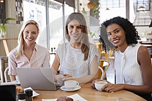 Portrait Of Three Businesswomen Meeting In Coffee Shop