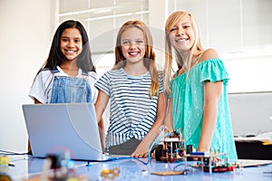 Portrait Of Three Female Students Building And Programing Robot Vehicle In School Computer Class
