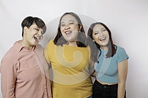 A portrait of three friends are smiling expressing happy feeling, isolated by white background