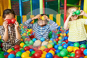 Happy Kids Playing in Ball Pit photo