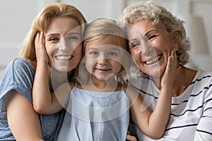 Portrait of three generations of women hugging