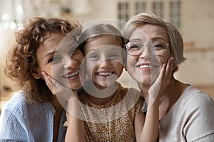 Portrait of three generations of women pose together