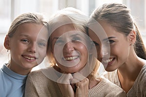 Portrait of three generations of women posing at home