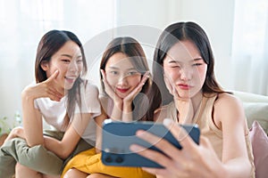 Portrait of Three Happy Asian Women friends taking a selfie