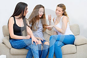 Portrait of three happy pretty young women at home