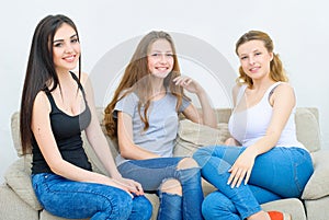 Portrait of three happy pretty young women at home