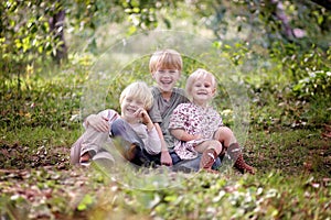 Three Happy Young Children Laughing Outside