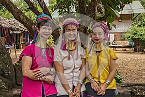 portrait of three long-necked Karen women with brass neck rings at Pai in Mae Hong Son, Thailand