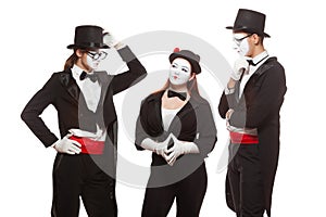 Portrait of three mime artists performing, isolated on white background. Mimes stand thinking. Symbol of finding