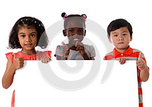 Portrait three of multiracial kids in studio with white board.Isolated