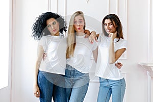 Portrait of three seductive multiethnic women standing together