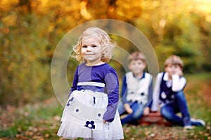 Portrait of three siblings children. Little cute toddler sister girl and Two kids brothers boys on background having fun