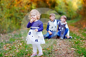 Portrait of three siblings children. Little cute toddler sister girl and Two kids brothers boys on background having fun