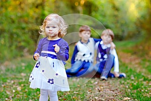 Portrait of three siblings children. Little cute toddler sister girl and Two kids brothers boys on background having fun