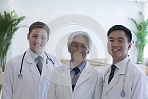 Portrait of three smiling doctors in the hospital, multi-ethnic group