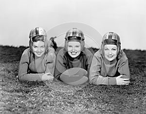 Portrait of three women in football helmets