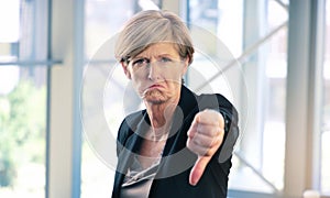 Portrait, thumbs down and mature business woman with sad face, opinion or no fail sign. Negative, hand gesture and